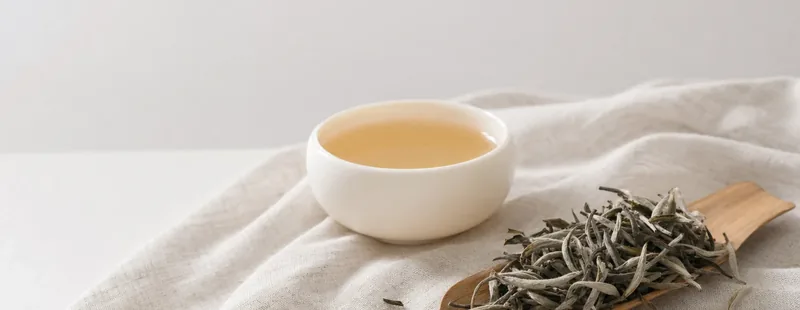 Tea leaves and brewing setup for White teaware matches